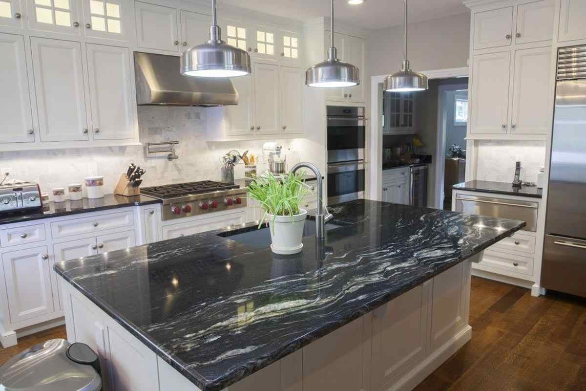 Surprising mixture of black granite with white cabinets