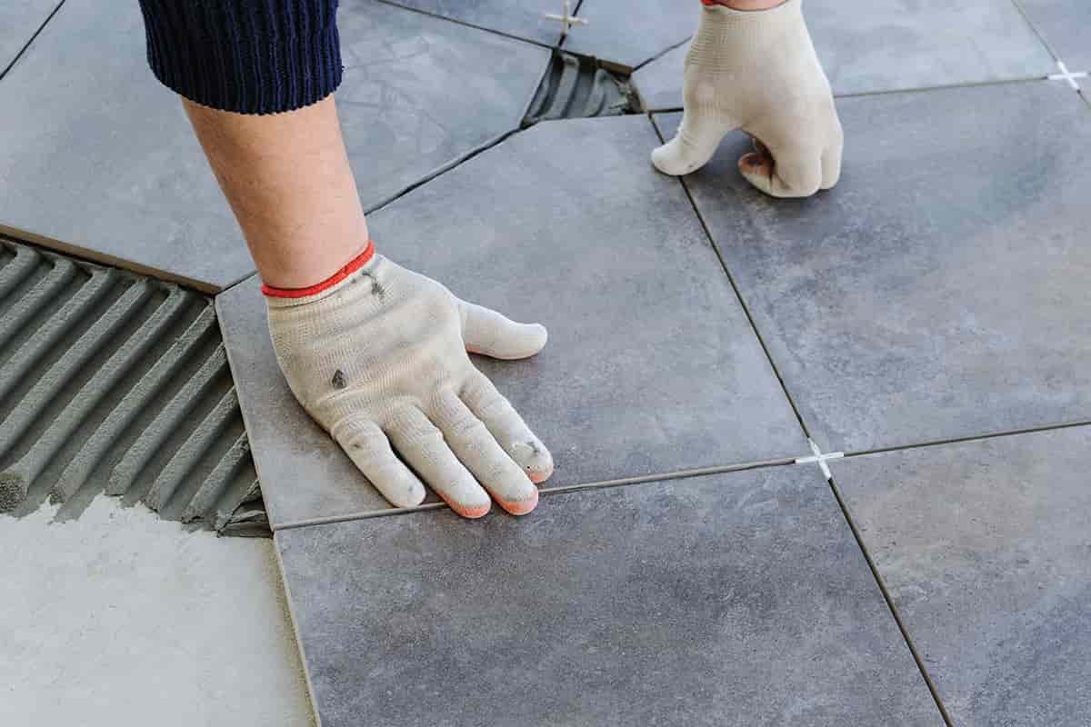 laying ceramic tiles on concrete floor outdoor